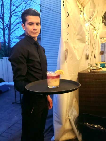 server holding a tray witn a cocktail at bartenders vip mix private event