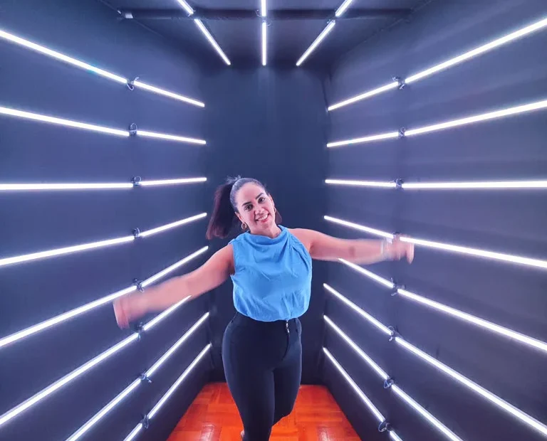 Woman posing inside an illuminated LED Backdrop Tunnel at an event