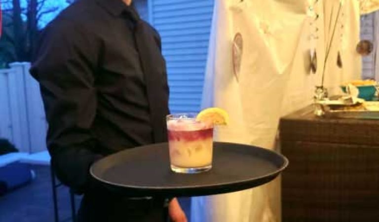 server holding a tray witn a cocktail at bartenders vip mix private event